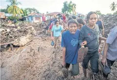  ?? REUTERS ?? A woman cries after locating her relative’s remains on Tuesday in East Flores, East Nusa Tenggara province.