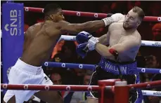  ?? AP; Getty Images ?? Anthony Joshua, left, throws a right at Otto Wallin during their fight in Saudi Arabia this month; below, David Benavidez on his way to victory over Demetrius Andrade