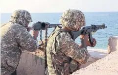  ?? AFP ?? Members of the Islamic Revolution­ary Guard Corps take part in a drill in the south of Iran on Tuesday.