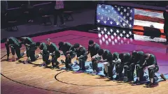  ?? JASEN VINLOVE/ USA TODAY SPORTS ?? Celtics players knelt during the national anthem before the game Wednesday against the Heat at American Airlines Arena.