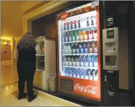  ?? Associated Press ?? A Coca-Cola vending machine sits in the basement of the state Capitol as members of the Legislatur­e debate a ban on local soda taxes in Sacramento, Calif., two years ago, a measure similar to one proposed to help close a budget gap in Connecticu­t this year.