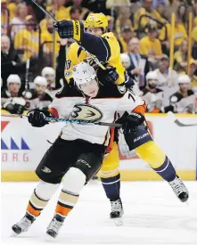  ??  ?? Anaheim Ducks defenceman Brandon Montour, front, and Nashville Predators right wing James Neal battle mid-ice.