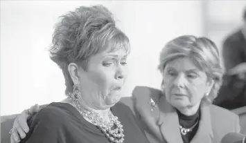  ?? AGENCE FRANCE PRESSE ?? Attorney Gloria Allred (right) hugs Beverly Young Nelson as she reacts during a press conference in New York alleging that Roy Moore sexually assaulted Nelson when she was a minor in Alabama without her consent.