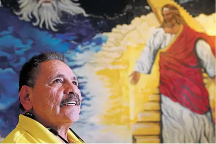  ?? GABRIELA CAMPOS/THE NEW MEXICAN ?? Juan Valdez, pictured at home in front of a mural created by a former client, helps individual­s in the community struggling with addiction, homelessne­ss and mental health issues.