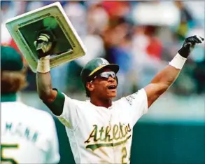  ?? Associated Press file photo ?? Rickey Henderson holds up third base after breaking Lou Brock’s all-time career record for stolen bases.