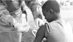  ??  ?? A Congolese health worker administer­s Ebola vaccine to a boy who had contact with an Ebola sufferer in the village of Mangina in North Kivu province of the Democratic Republic of Congo. — Reuters photo