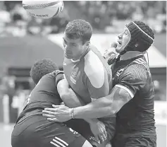  ?? — AFP photo ?? New Zealand (black) and Russia (blue) battle for a win during the HSBC Canada Sevens Vancouver tournament at BC Place Stadium in Vancouver.