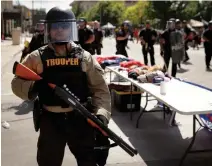  ?? CHARLIE RIEDEL
THE ASSOCIATED PRESS ?? A trooper stands outside the arena where U.S. President Donald Trump held his campaign rally in Tulsa, Okla., on Saturday.