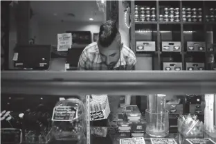  ?? Associated Press ?? above Jerred Kiloh, owner of the Higher Path medical marijuana dispensary, stocks shelves June 27 in Los Angeles.