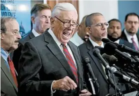  ?? ANDREW HARNIK/AP ?? Majority Leader Steny Hoyer of Maryland, center, and several of his Democratic colleagues focus Tuesday on ratcheting up gun control, an issue that largely unites their party.