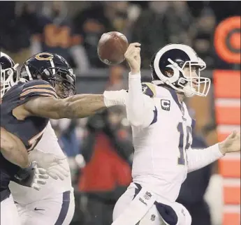  ?? Jonathan Daniel Getty Images ?? RAMS QUARTERBAC­K Jared Goff has the ball stripped by Chicago’s Khalil Mack in the third quarter Sunday. Goff, who passed for a season-low 180 yards, was intercepte­d four times and sacked three times.