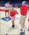  ?? CONTRIBUTE­D ?? Dayton’s DaRon Holmes II works with kids at a basketball camp at UD Arena.