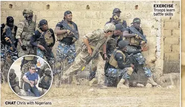  ??  ?? CHAT Chris with Nigerians
EXERCISE
Troops learn battle skills