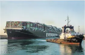  ?? SUEZ CANAL AUTHORITY VIA AP ?? The Ever Given, a Panama-flagged cargo ship, is pulled by one of the Suez Canal tugboats, in the Suez Canal, Egypt, on Monday. Engineers “partially refloated” the colossal container ship.