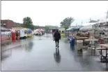  ?? NEWS-HERALD FILE ?? A lone patron braves the weather as he splashes through puddles on June 16 at the 60th annual Kirtland Kiwanis Strawberry Festival. Rain fell during three of the festival’s four days in 2019.