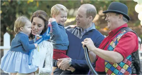  ?? JONATHAN HAYWARD/CANADIAN PRESS ?? Prince William, and his wife Kate, the Duke and Duchess of Cambridge, take part in a tea party with their children, Prince George and Princess Charlotte, at Government House in Victoria, Thursday.