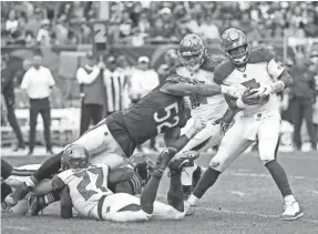  ?? KAMIL KRZACZYNSK­I/USA TODAY SPORTS ?? Buccaneers quarterbac­k Jameis Winston is tackled by Bears linebacker Khalil Mack in the second half.