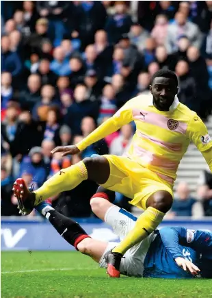  ??  ?? Joe Garner’s diving header evades Viktor Noring in nets for Hearts to open the scoring in the seventh minute at Ibrox yesterday