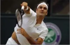 ?? ALASTAIR GRANT — THE ASSOCIATED PRESS FILE ?? Roger Federer Wimbledon. serves to Marin Cilic in the final match at