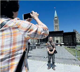  ?? SEAN KILPATRICK/THE CANADIAN PRESS ?? Tourists visit Parliament Hill in Ottawa last week as preparatio­ns for Canada Day are underway. Be alert but not alarmed, police are urging Canadians who will attend Canada 150 celebratio­ns next month.