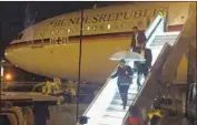 ?? Joerg Blank DPA ?? CHANCELLOR Angela Merkel departs a German Airbus jetliner last year due to technical problems.