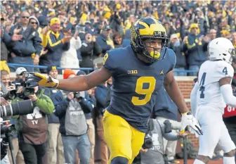  ?? ASSOCIATED PRESS ?? HAIL TO THE VICTORS: Michigan’s Donovan Peoples-Jones celebrates a touchdown during the No. 5 Wolverines’ 42-7 rout of No. 14 Penn State yesterday in Ann Arbor, Mich. Michigan likely will move into the top four of the College Football Playoff poll.