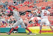  ?? [TOM GANNAM/THE ASSOCIATED PRESS] ?? Reds first baseman Joey Votto stretches for the ball and records the out against the Cardinals’ Aledmys Diaz in the first inning.