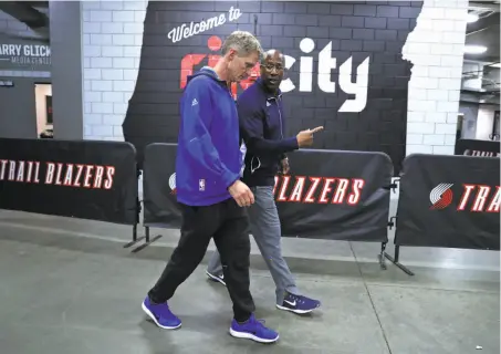  ?? Scott Strazzante / The Chronicle ?? Warriors head coach Steve Kerr and interim head coach Mike Brown head to the team bus after a shootaroun­d Monday.