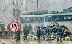  ?? — PTI ?? Security personnel carry out the rescue and relief works at the site of suicide bomb attack at Lathepora Awantipora in Pulwama district of Kashmir.