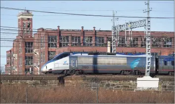  ?? Brian A. Pounds / Hearst Connecticu­t Media ?? An Acela train heads across the east side of Bridgeport on Wednesday. The Acela can hit 150 mph but averages about half that speed due to design and right-of-way constraint­s. A new high-speed rail concept has been quietly germinatin­g in Connecticu­t, one that would go inland instead of along the shoreline.