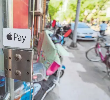  ?? ?? An Apple Pay logo on a shop in Shanghai as the tech giant warns of online scams
