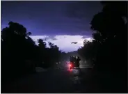  ?? MATIAS DELACROIX — THE ASSOCIATED PRESS ?? Commuters travel on a bus popularly referred to as “taptap” during a tropical storm Aug. 15in Miragoane, Haiti.