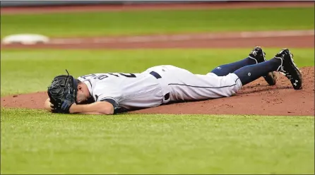  ?? STEVE NESIUS/AP PHOTO ?? Tampa Bay Rays starter Jake Odorizzi lays prone on the mound after he was hit in the right leg by a line drive from Eduardo Nunez of the Boston Red Sox during the fifth inning Wednesday’s game in St. Petersburg, Fla. The Red Sox went on to beat the...