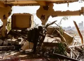  ?? MENAHEM KAHANA/AFP VIA GETTY IMAGES ?? An Israeli soldier positioned in al-Bureij in the central Gaza Strip. Israel has vowed to keep going until it destroys Hamas.