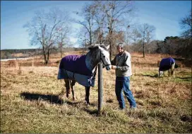  ?? BRANDEN CAMP / FOR THE AJC ?? Frans Insinger, shown recently with his horse Raine at Bentfork Farms in McDonough, gave up on full insurance. He and his wife bought a “short-term” plan.