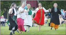  ?? (NWA Democrat-Gazette File Photo/Andy Shupe) ?? Jan Luecking (from left), Mary Droho, Susan Bearden, Dessie Wewers and Trish Nelson, all members of the Fayettevil­le Internatio­nal Folk Dancers, perform traditiona­l dances for a large crowd during a previous Internatio­nal Celebratio­n at the Botanical Garden of the Ozarks in Fayettevil­le. The event, the final Tyson Tuesday Nights event of the summer in 2017, featured performanc­es, displays and informatio­n from more than a dozen countries.