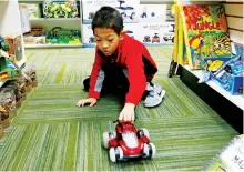  ??  ?? Paxton Mathis, 8, plays with a remote-control car at Time 4 Toys, in Flowood, Miss. The youngest child of store owner Bethany Mathis, Paxton, who has sensory processing disorder, often tests out some of the multipurpo­se toys offered in his mother’s toy...