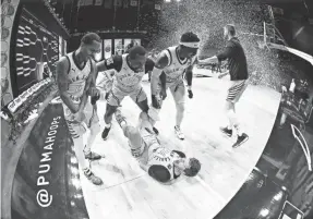  ?? BEN SOLOMON/THE BASKETBALL TOURNAMENT ?? The Golden Eagles surround Travis Diener after he hit a 3-pointer to win The Basketball Tournament on Tuesday.