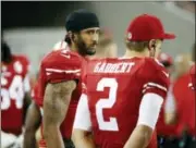  ?? TONY AVELAR — THE ASSOCIATED PRESS ?? San Francisco 49ers quarterbac­ks Colin Kaepernick, left, and Blaine Gabbert stand on the sideline during the second half of an NFL preseason football game against the Green Bay Packers on Friday.