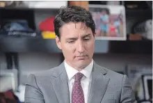  ?? CHRIS YOUNG THE CANADIAN PRESS ?? Prime Minister Justin Trudeau sits in Toronto Mayor John Tory's office at city hall prior to their meeting on Friday.