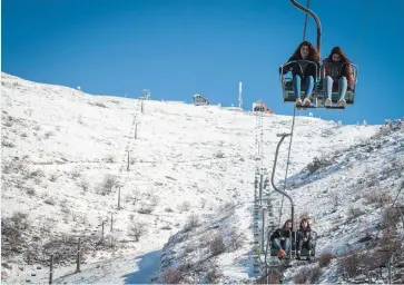  ?? (Basel Awidat/Flash90) ?? VISITORS RIDE the ski lift on Mount Hermon yesterday, along the Syrian border. As the Assad regime advances against rebel forces, are tensions approachin­g the Israeli ski resort?