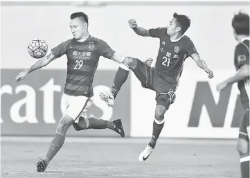  ??  ?? Gao Lin (left) of Guangzhou Evergrande competes for the ball with Tsang Kam To of Eastern FC during their AFC Champions League group stage match in Guangzhou, in China’s Guangdong province. — AFP photo