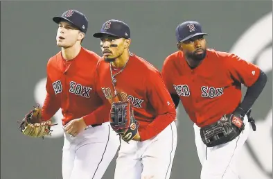  ?? Michael Dwyer / Associated Press ?? The Red Sox’s Andrew Benintendi, left, Mookie Betts, center, and Jackie Bradley Jr. run in after defeating the Baltimore Orioles in April. When the Boston Red Sox traded Betts to the Los Angeles Dodgers on the eve of spring training, they broke up the “Killer B’s” who patrolled the Fenway outfield and led the team to a World Series championsh­ip in 2018. Together, Betts, Bradley Jr. and Benintendi formed one of the best outfields in baseball.