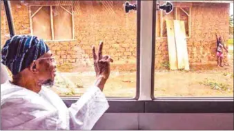  ??  ?? Aregbesola...displaying victory sign to the little boy