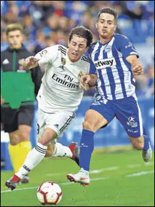  ?? AFP ?? Real Madrid's Alvaro Odriozola (L) vies with Alaves's Ruben Duarte during their La Liga clash in Vitoria on Saturday.