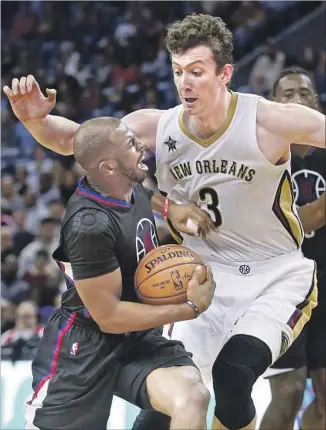  ?? Gerald Herbert Associated Press ?? A 3-ON-3 MATCHUP appears to be to Pelicans’ advantage as 7-footer Omer Asik defends 6-foot Clippers guard Chris Paul. But Paul outplayed New Orleans’ center, totaling 17 points and 13 assists.