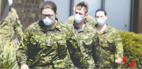  ?? VERONICA HENRI / POSTMEDIA NEWS FILES ?? Members of the Canadian Armed Forces head into Orchard Villa long-term care home in Pickering, Ont., in the first week of May. Now it's military people with experience in logistics who are overseeing the vaccine rollouts for Canada and Ontario.