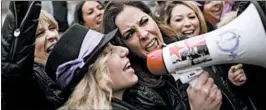  ?? FRANCISCO SECO/AP ?? Women shout slogans during a protest Thursday in Madrid on Internatio­nal Women's Day. In Barcelona, protesters disrupted traffic. Protests and strikes were held in several cities.