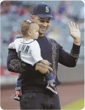  ??  ?? JOHN LEGEND The singer always looks sharp, and when he helped daughter Luna throw out the first pitch at a recent Seattle Mariners game, he was wearing an Alexander McQueen sweatshirt.