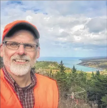  ??  ?? Jonathan Riley stands at the top of Gulliver’s Cove last July in this file photo.